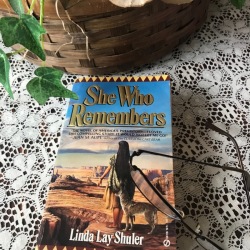 Museum Volunteer, Susan Miller, is reading She Who Remembers by Linda Lay Shuler